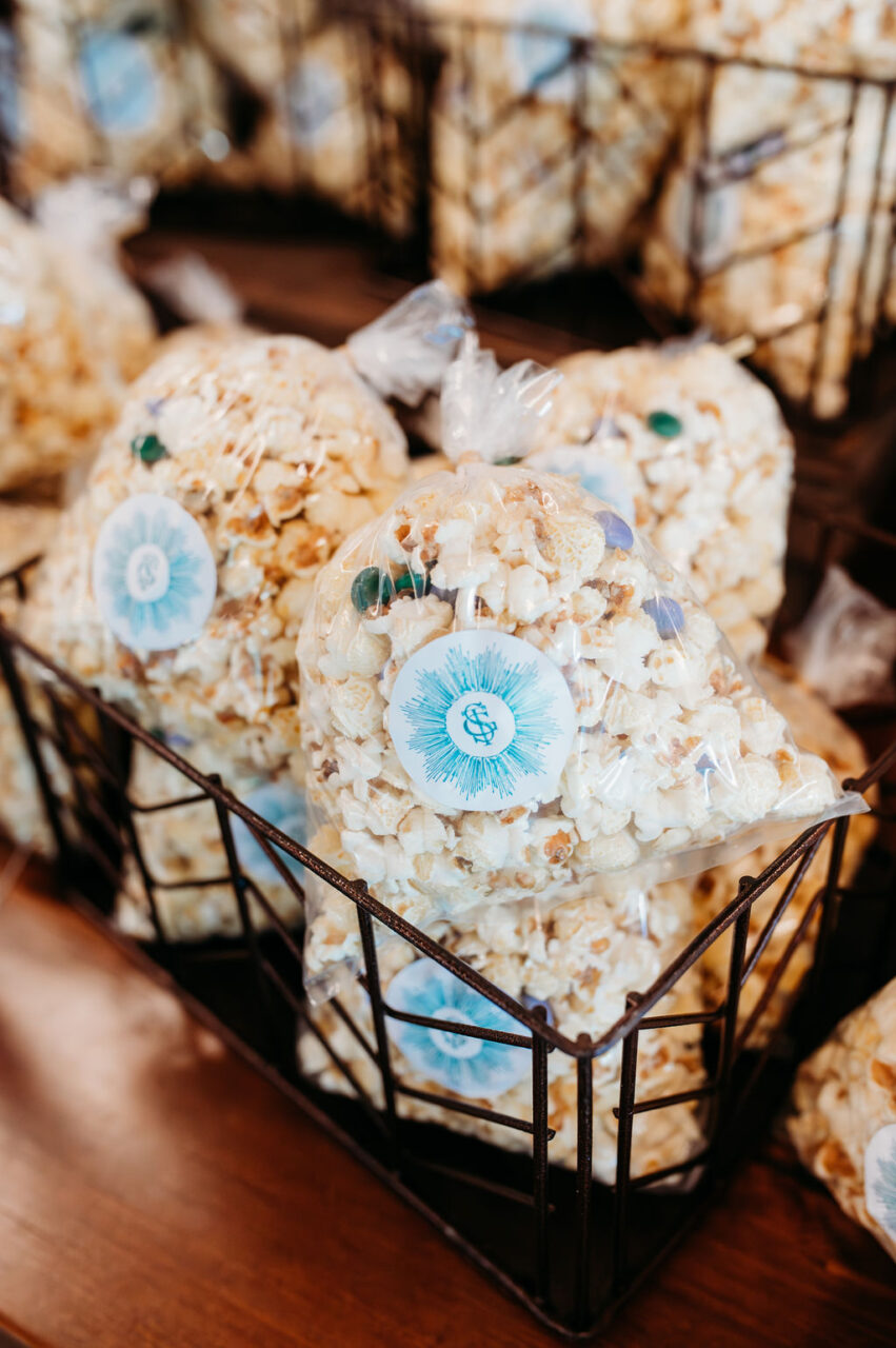 Custom branded favor stickers on popcorn bags for a business event