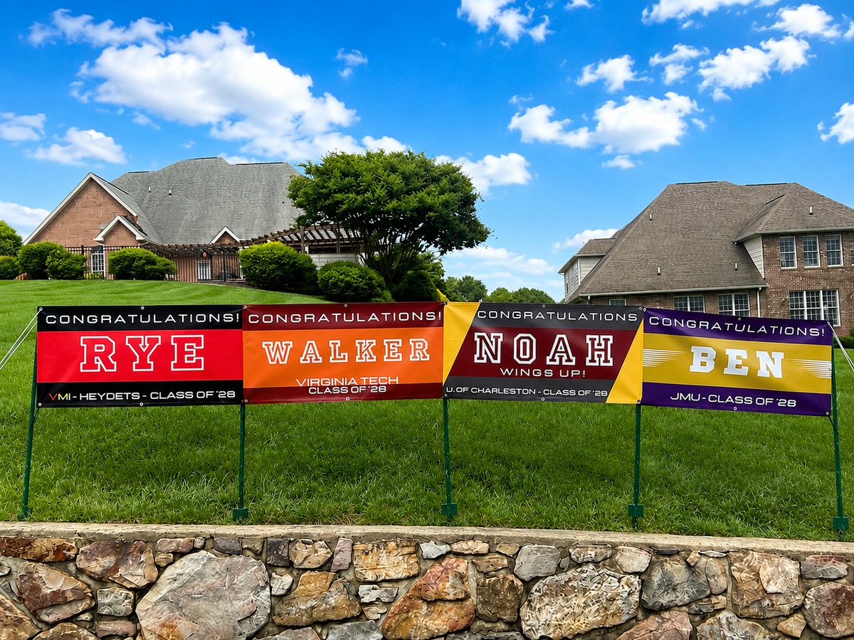 Custom graduation banners displayed outdoors featuring personalized senior night and college signing banners for VMI, Virginia Tech, University of Charleston, and JMU students.