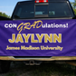 Pickup truck tailgate — banner propped on an open tailgate, sunny outdoor setting