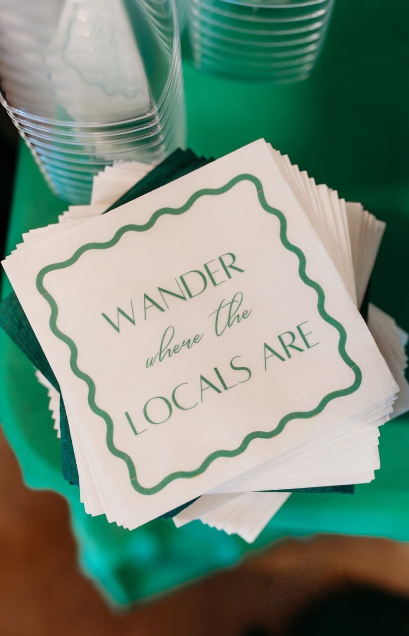 Custom printed cocktail napkins displayed at a branded business event